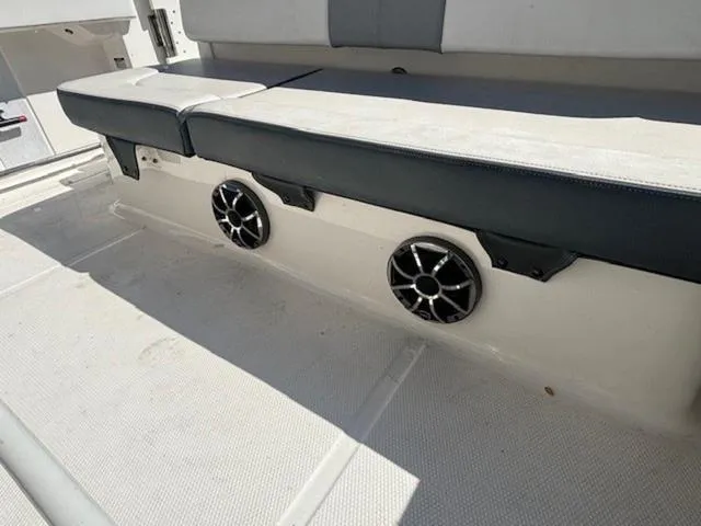 Slide: The Image of 2021 Robalo R222 boat interior with speakers and cushioned seating. - 14