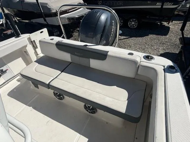 Slide: The Image of 2021 Robalo R222 boat interior with cushioned seating and Yamaha outboard motor. - 15