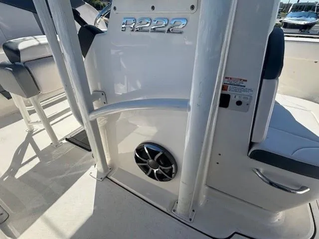 Slide: The Image of 2021 Robalo R222 boat interior with seating and speaker detail. - 17