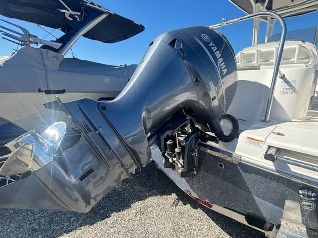 Slide: The Image of 2021 Robalo R222 boat with Yamaha outboard motor, parked on gravel. - 21