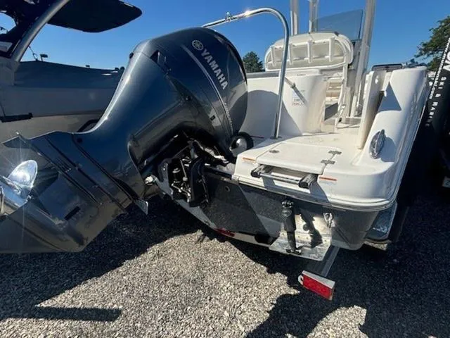 Slide: The Image of 2021 Robalo R222 boat with Yamaha outboard motor, parked on gravel. - 24