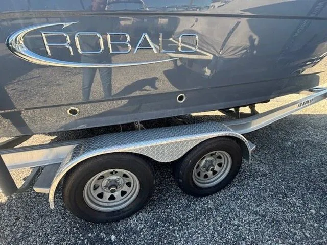 Slide: The Image of 2021 Robalo R222 boat on a dual-axle trailer, side view. - 25