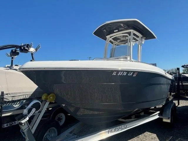 Slide: The Image of 2021 Robalo R222 boat on trailer under clear blue sky. - 3
