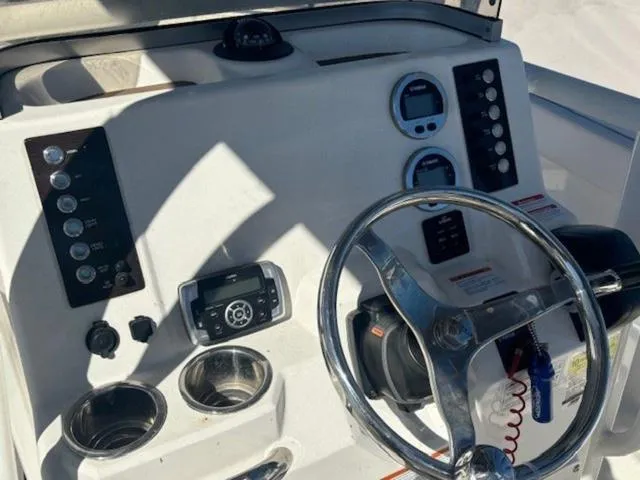 Slide: The Image of 2021 Robalo R222 boat dashboard with steering wheel and control panel. - 5