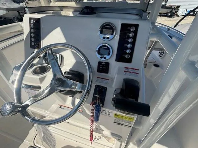 Slide: The Image of 2021 Robalo R222 boat dashboard with steering wheel and control panel. - 6