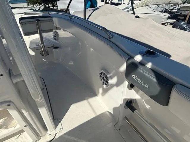 Slide: The Image of 2021 Robalo R222 boat interior, featuring sleek white design and modern amenities. - 7