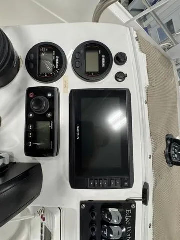 Slide: The Image of Edgewater 170CC 2019 boat dashboard with Garmin display and Yamaha gauges. - 15