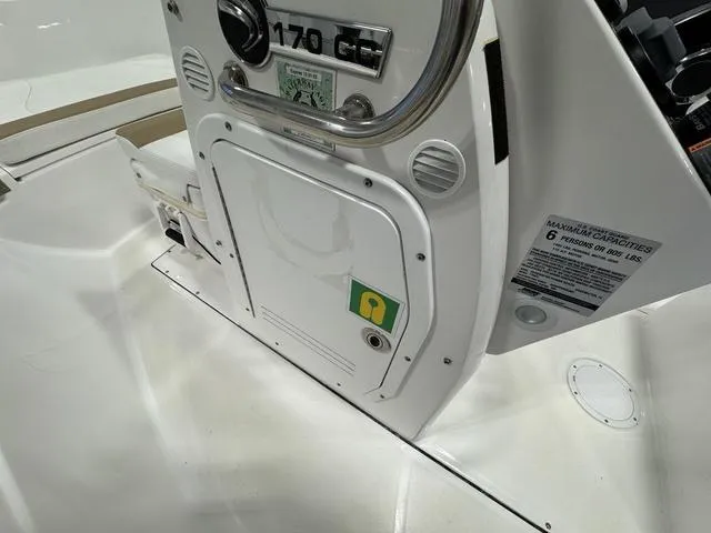 Slide: The Image of 2019 Edgewater 170CC boat console with storage compartment and capacity label. - 17