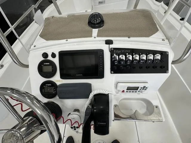 Slide: The Image of 2019 Edgewater 170CC boat dashboard with navigation controls and instruments. - 8