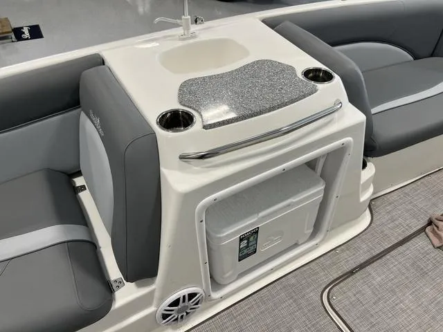 Slide: The Image of 2023 NauticStar 203 SC boat interior with sink, cup holders, and storage compartment. - 11
