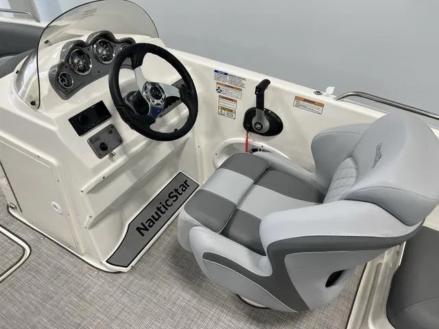 Slide: The Image of 2023 NauticStar 203 SC boat cockpit with steering wheel and gray captain's chair. - 12