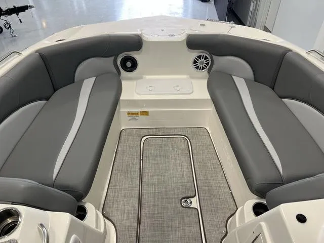 Slide: The Image of 2023 NauticStar 203 SC boat interior with gray seating and speakers. - 13