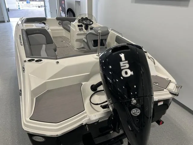 Slide: The Image of 2023 NauticStar 203 SC boat with 150 HP engine, featuring spacious seating and modern design. - 5