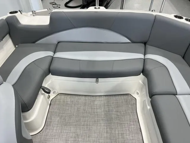 Slide: The Image of 2023 NauticStar 203 SC boat interior with gray cushioned seating and textured flooring. - 8