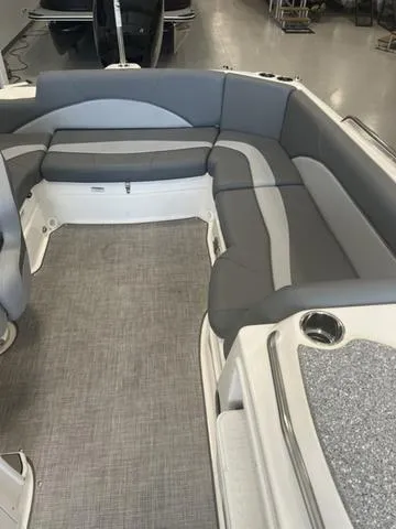Slide: The Image of 2024 NauticStar 203 SC boat interior with gray seating and carpeted flooring. - 8