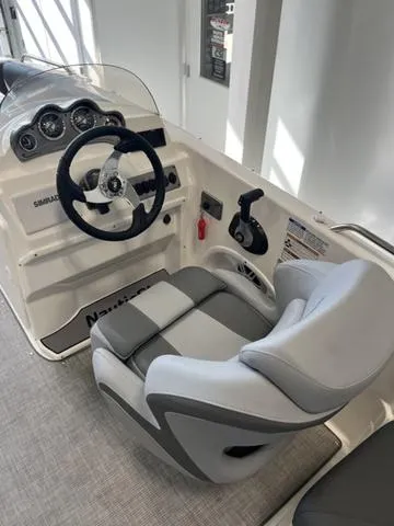 Slide: The Image of 2024 NauticStar 203 SC boat interior with steering wheel and captain's chair. - 9