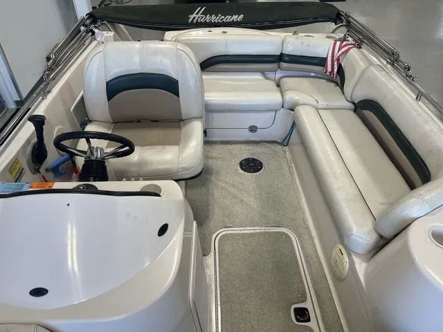 Slide: The Image of 2003 Hurricane GS 203 Fundeck boat interior with white seating and steering wheel. - 4
