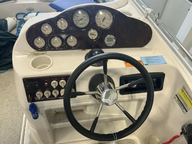 Slide: The Image of 2003 Hurricane GS 203 Fundeck boat dashboard with steering wheel and gauges. - 7