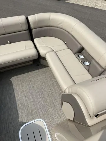 Slide: The Image of 2024 Bentley Pontoons Elite 223 Admiral 3/4 Tube interior with beige seating and cup holders. - 11