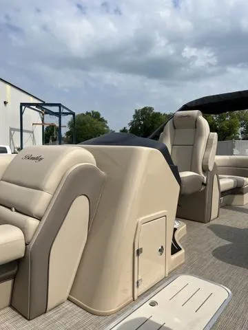 Slide: The Image of 2024 Bentley Pontoons Elite 223 Admiral 3/4 Tube interior with luxurious seating and helm. - 13