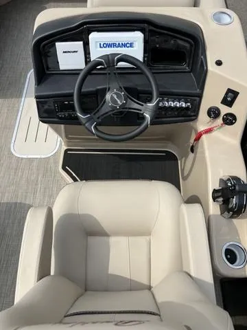 Slide: The Image of 2024 Bentley Pontoons Elite 223 Admiral dashboard with steering wheel and navigation system. - 15