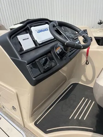 Slide: The Image of 2024 Bentley Pontoons Elite 223 Admiral dashboard with steering wheel and navigation equipment. - 16