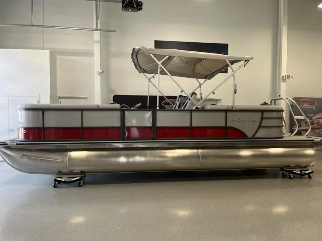 Slide: The Image of 2024 Bentley Pontoons Legacy 243 Navigator 3/4 Tube in showroom, side view. - 1
