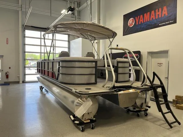 Slide: The Image of 2024 Bentley Pontoons Legacy 243 Navigator 3/4 Tube in showroom with Yamaha sign. - 2