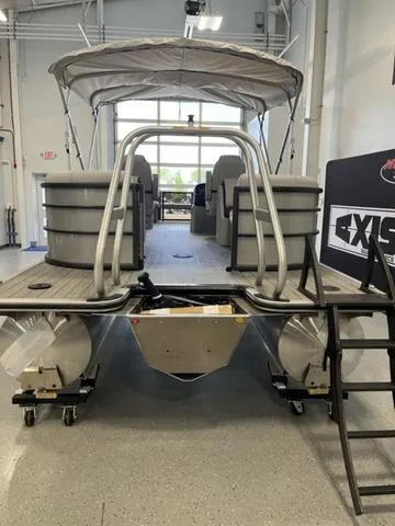 Slide: The Image of 2024 Bentley Pontoons Legacy 243 Navigator 3/4 Tube in showroom, rear view. - 3