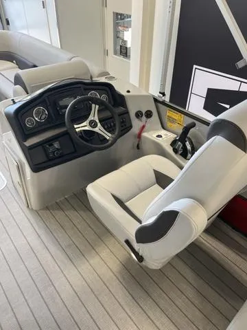 Slide: The Image of 2024 Bentley Pontoons Legacy 243 Navigator 3/4 Tube helm with modern controls and seating. - 4