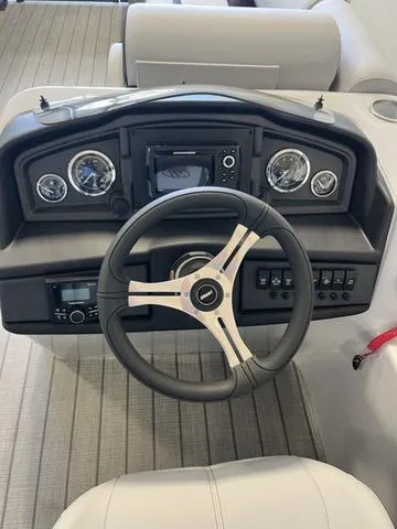 Slide: The Image of 2024 Bentley Pontoons Legacy 243 Navigator dashboard with steering wheel and gauges. - 5