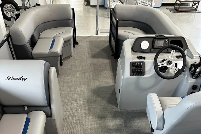 Slide: The Image of 2025 Bentley Pontoons Bolt interior with modern seating and steering console. - 5