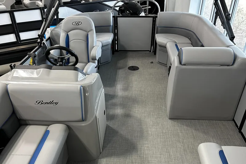 Slide: The Image of 2025 Bentley Pontoons Bolt interior with gray seating and steering console. - 6