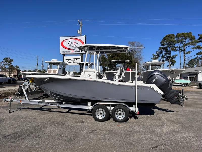 The Image of 2025 Tidewater 210 LXF boat on trailer, parked outdoors at a marina. - 0