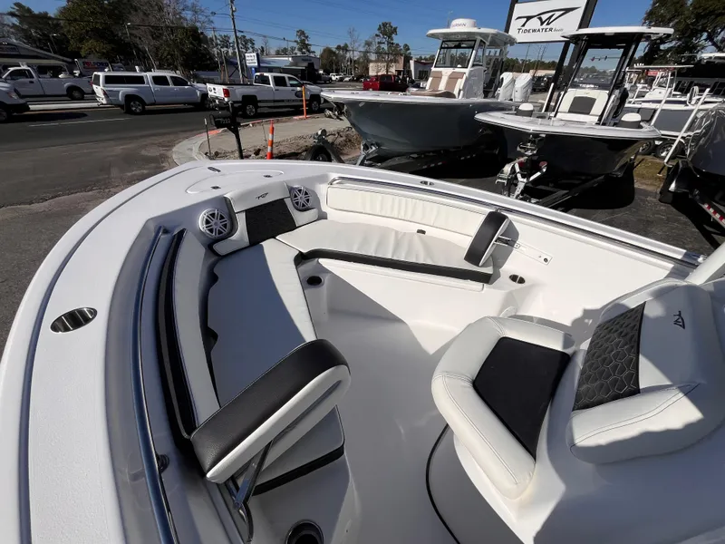 Slide: The Image of 2025 Tidewater 210 LXF boat interior with seating and speakers, displayed outdoors. - 10