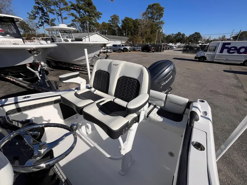 Slide: The Image of 2025 Tidewater 210 LXF boat with dual seats and Yamaha engine in a marina setting. - 12