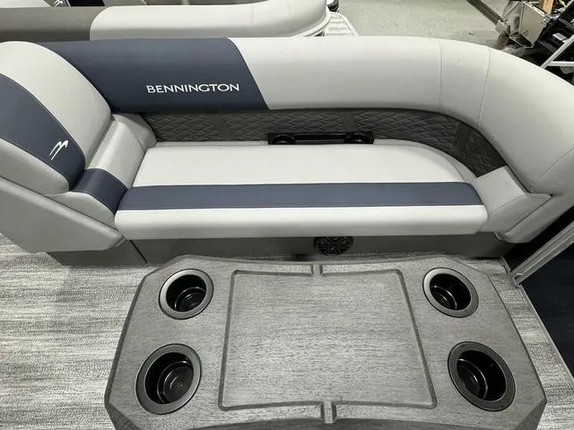 Slide: The Image of 2025 Bennington 23 SSR boat interior with cushioned seating and cup holders. - 14