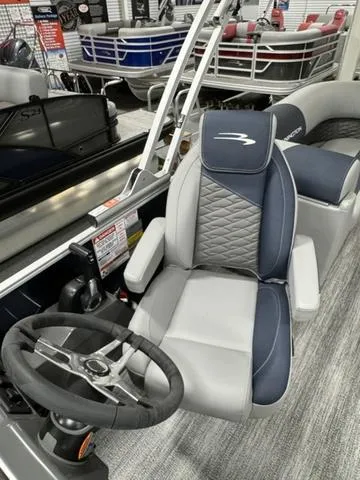 Slide: The Image of 2025 Bennington 23 SSR boat interior with steering wheel and cushioned seating. - 18