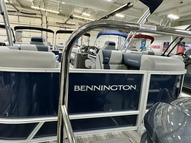 Slide: The Image of 2025 Bennington 23 SSR pontoon boat interior in showroom setting. - 21
