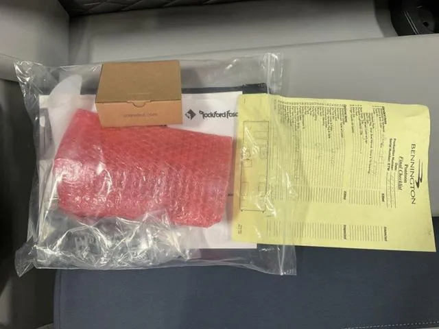 Slide: The Image of Bennington 23 SSB 2025 documents and accessories in a plastic bag on a seat. - 14