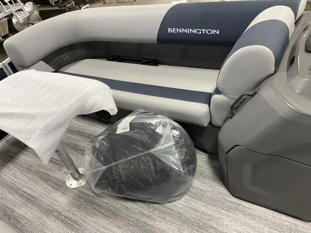 Slide: The Image of 2025 Bennington 23 SSB boat interior with cushioned seating and table. - 3