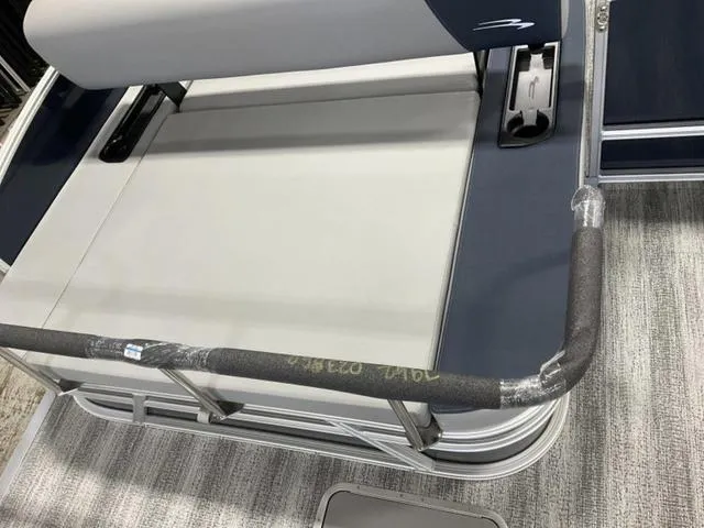 Slide: The Image of 2025 Bennington 23 SSB boat seat with protective railing and gray upholstery. - 8