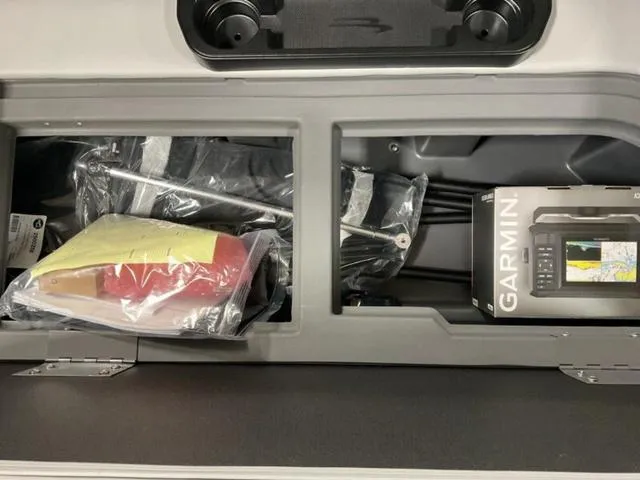 Slide: The Image of Storage compartment of 2025 Bennington 22 SSR with Garmin device and accessories. - 12