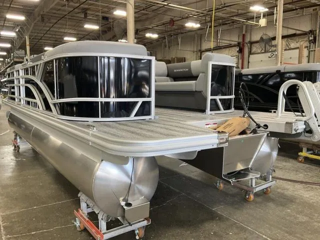Slide: The Image of 2025 Bennington 22 SSR pontoon boat in a factory setting, showcasing sleek design and craftsmanship. - 13