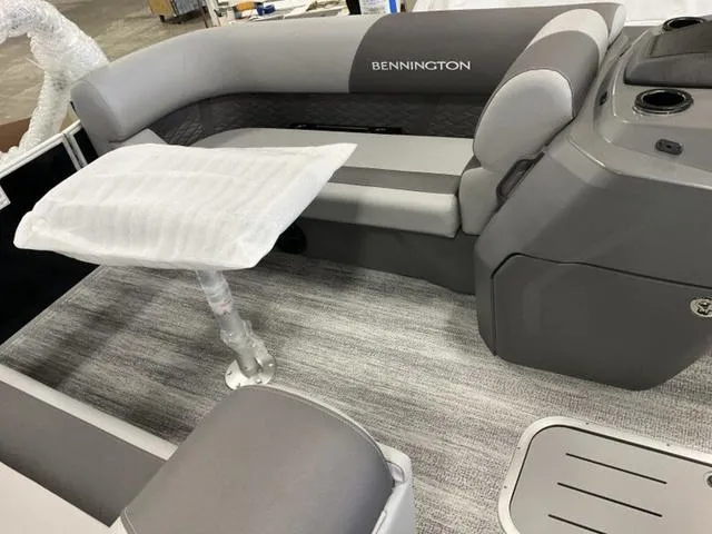 Slide: The Image of 2025 Bennington 22 SSR boat interior with gray seating and table. - 4