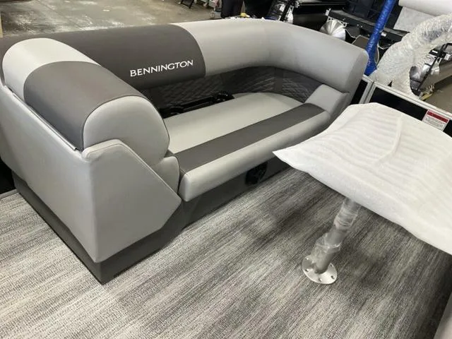 Slide: The Image of 2025 Bennington 22 SSR boat interior with gray seating and table. - 8