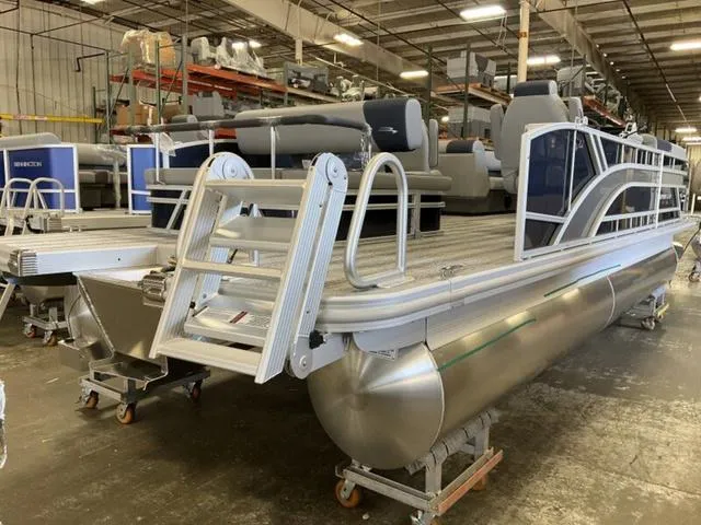 Slide: The Image of 2025 Bennington 22 SSB pontoon boat in a warehouse, showcasing sleek design and modern features. - 10