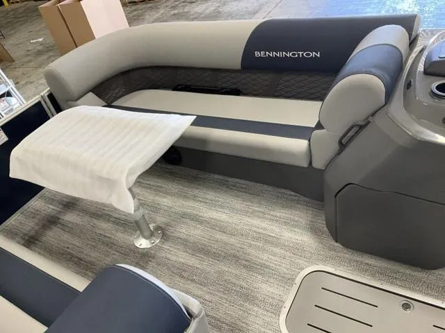 Slide: The Image of 2025 Bennington 22 SSB pontoon boat interior with gray seating and table. - 3