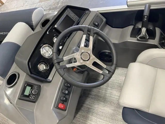 Slide: The Image of 2025 Bennington 22 SSB boat dashboard with steering wheel and control panel. - 4