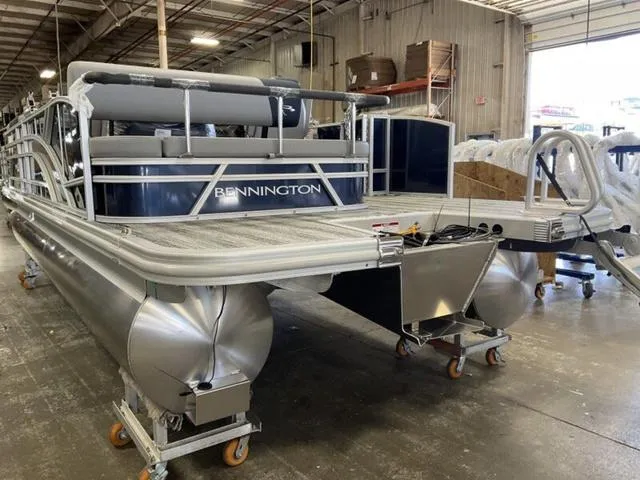 Slide: The Image of 2025 Bennington 22 SSB pontoon boat in a warehouse setting. - 9